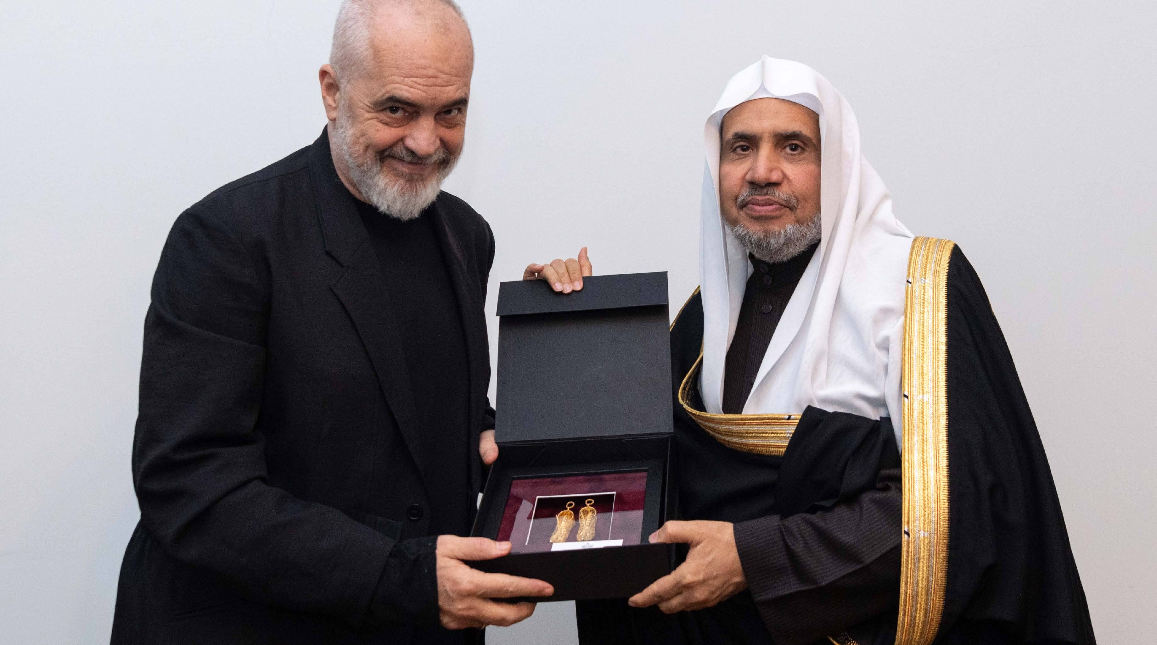 His Excellency Sheikh Dr. Mohammad bin Abdulkarim Al-Issa receives a gift from His Excellency the Albanian Prime Minister, Mr. Edi Rama, during their meeting