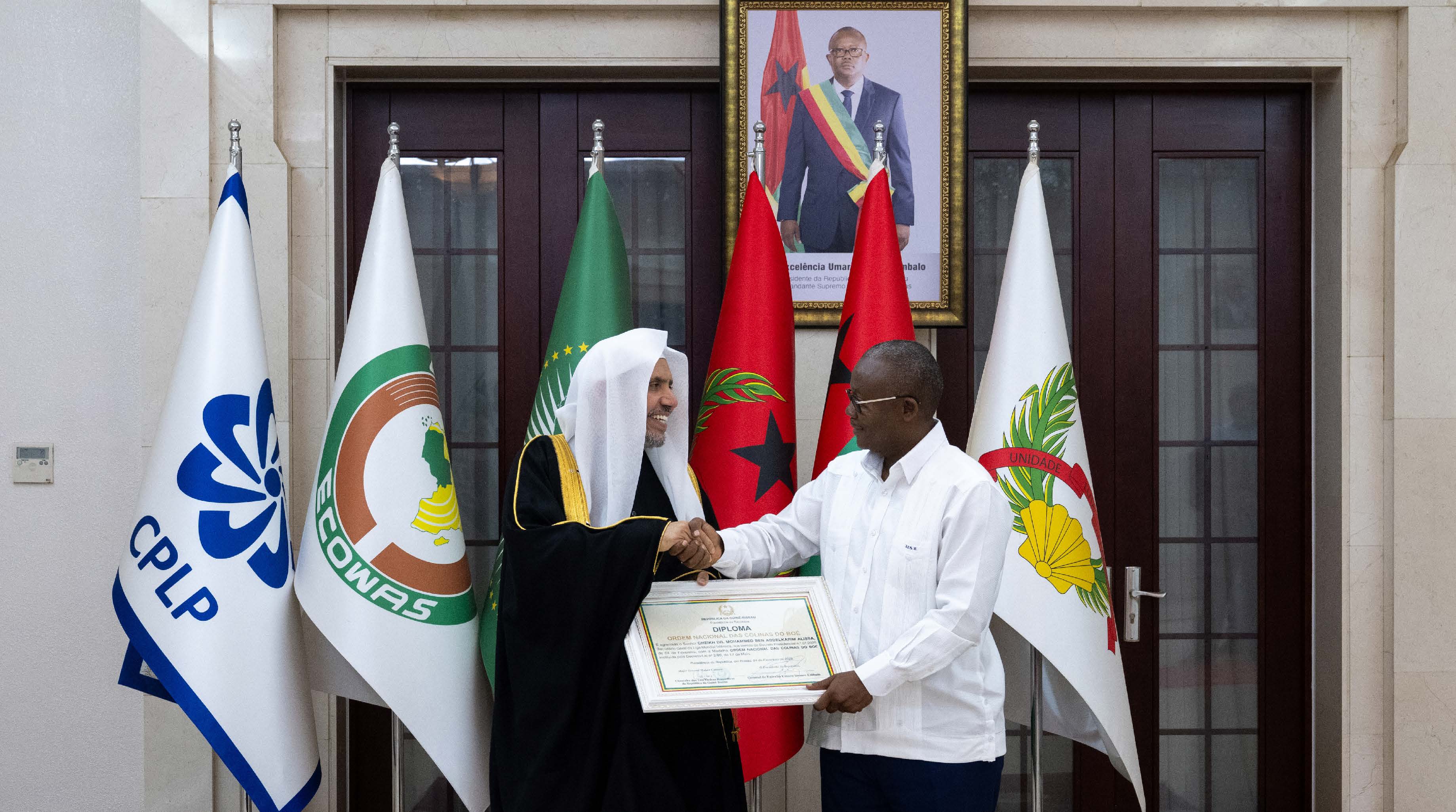 His Excellency Sheikh Dr. Mohammad bin Abdulkarim Al-Issa receives the document of the High Order of Honor (Colinas de Boé) from His Excellency the President of the Republic of Guinea-Bissau, Mr. Umaro Sissoco Embaló